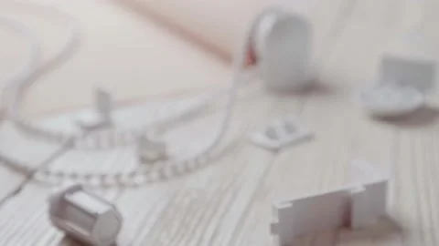 Beige roller blind and spare parts on a white wooden table. Stock Footage 147961852