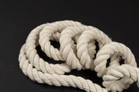 Beige rope on dark background close up Stock-Fotos