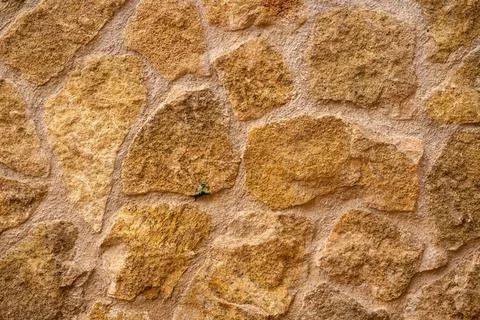 Beige rough stone wall texture Stock Photos