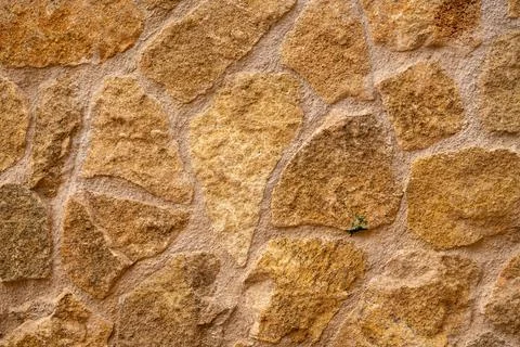 Beige rough stone wall texture Stock Photos