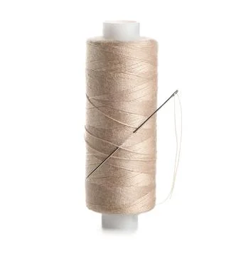 Beige sewing thread with needle on white background Stock Photos