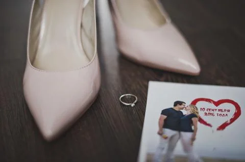 Beige shoes and a ring on the table 7778. Stock Photos