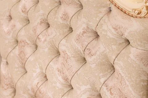 Beige soft tapestry pattern background with symmetrical buttons on the corners Stock Photos