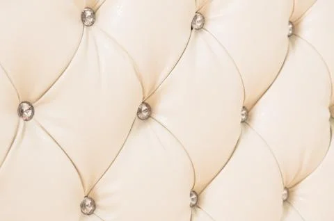 Beige soft tapestry pattern background with symmetrical buttons on the corners Stock Photos