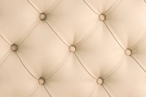 Beige soft tapestry pattern background with symmetrical buttons on the cor... Stock Photos