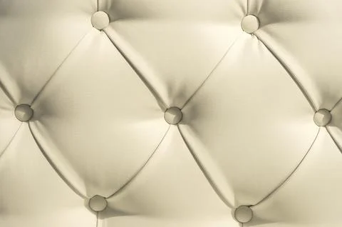 Beige soft tapestry pattern background with symmetrical buttons on the corners Stock Photos