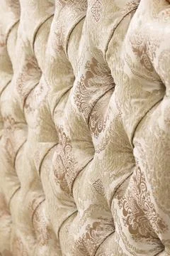 Beige soft tapestry pattern background with symmetrical buttons on the corners Stock Photos
