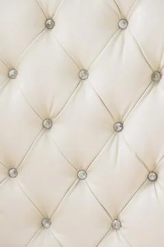 Beige soft tapestry pattern background with symmetrical buttons on the corners Stock Photos