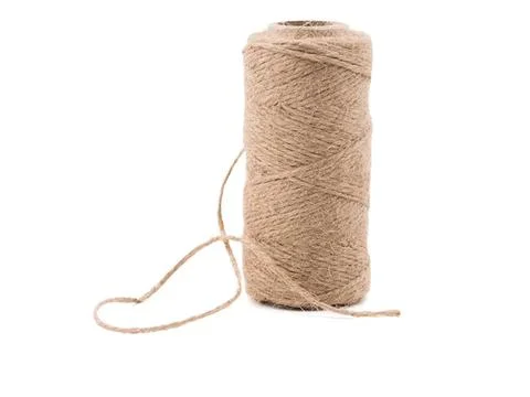 Beige spool of thread with loose end on white background Stock Photos