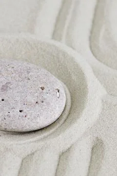 Beige stone on sand with pattern lines, zen garden,meditation, harmony. Banner. Stock Photos