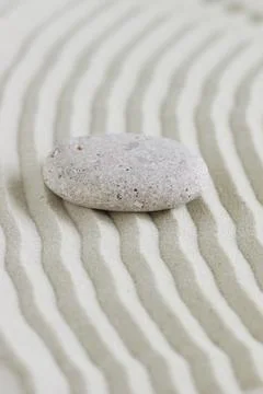 Beige stone on sand with pattern lines, zen garden,meditation, harmony. Banner. Stock Photos