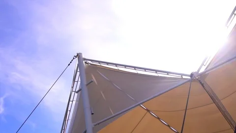 Beige stretch tent in summer sun rays on clear blue sky background Stock-Footage 88552990