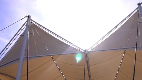 Beige stretch tent in summer sun rays on clear blue sky background Stock-Footage 88553360