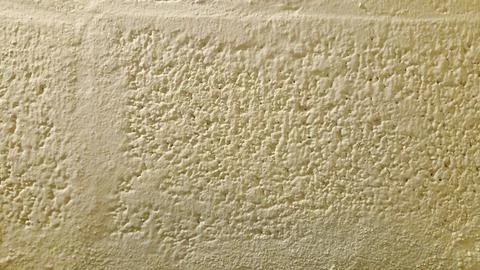 Beige Stucco Wall with Block Pattern Texture Background Construction Surface 库存照片