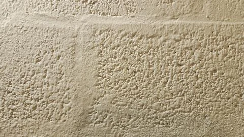 Beige Stucco Wall with Block Pattern Texture Background Construction Surface 库存照片