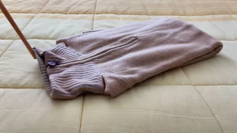 Beige Sweater with Ribbed Collar on Bedspread, Cozy Textile Mood 스톡 동영상 322510071