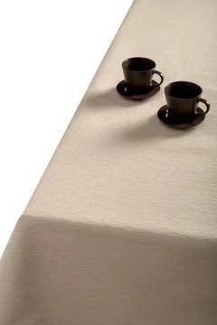 Beige tablecloth and pasuda on the table. Stock Photos