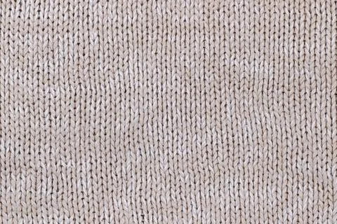 Beige texture of knitted wool sweater. Hand knitting. Stock Photos