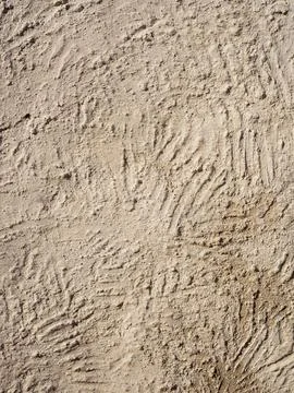Beige textured wall with plaster applied with putty knife in irregular dashes Stock Photos