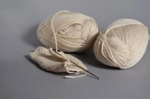Beige threads on a gray background. The concept of a favorite hobby handmade Stock Photos