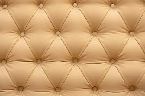 Beige tufted leather texture with buttons creating a luxury upholstery Stock Photos