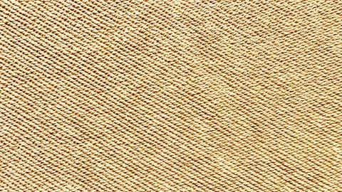 Beige twisted rope weave texture macro shot revealing intricate diagonal fibe Stock Photos