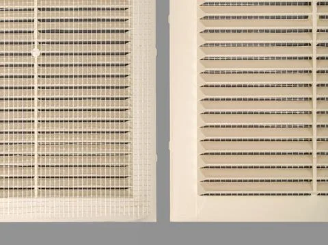 Beige ventilation grate on a gray background. Square shape, plastic materia.. Stock Photos