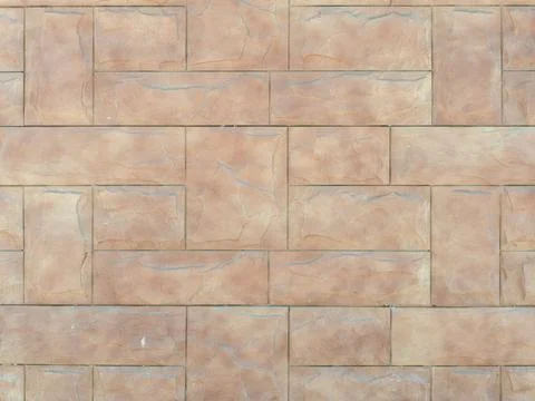 Beige wall with embossed rectangular tiles lined with pattern. Background 스톡 사진