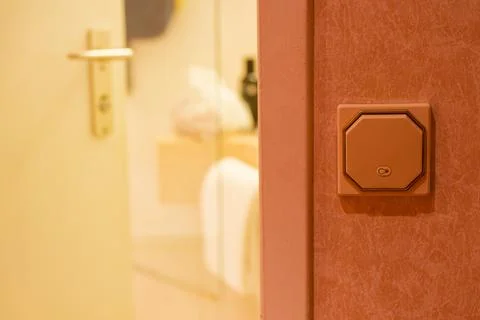 Beige wall with octagon switch and drawn light bulb icon Stock Photos