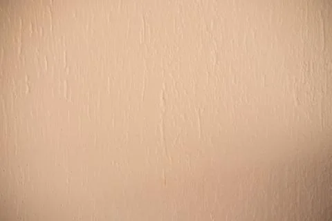 Beige wall texture creating an abstract wallpaper background with light shadow Stock Photos