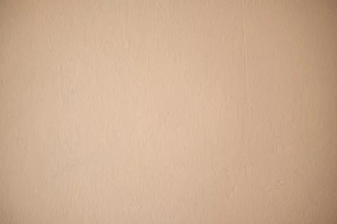 Beige wall with textured plaster surface creating a solid neutral background Foto stock