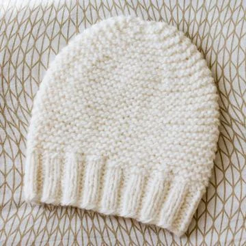 Beige white gradient hat wool knitted manually Stock Photos