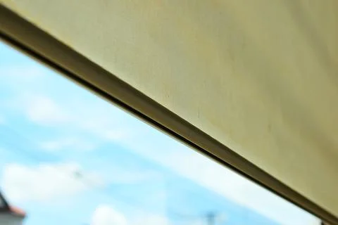 Beige window roller shade bar with blue sky view Stock Photos