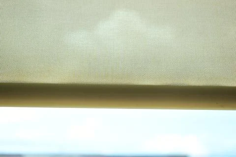 Beige window roller shade bar with blue sky view Stock Photos