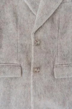 Beige wool blend coat with buttons and soft fuzzy texture Stock Photos