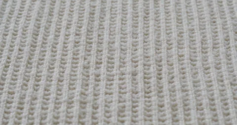 Beige woolen fabric close-up. Macro shooting of soft and warm knitted cloth Stock Footage 167899871