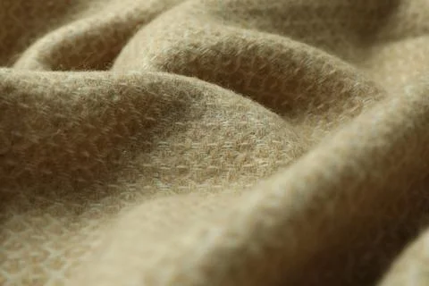 Beige woolen fabric with geometrical pattern, closeup Stock Photos