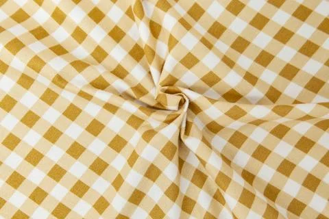Beige yellow checkered pattern cloth with a swirl and copy space Foto stock