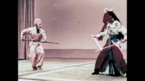 BEIJING - 1957 - In this Peking Opera, the Monkey King fights off a horde of Stock Footage 323261489