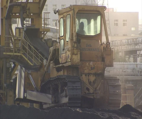 Beijing, China; MS tractor pushing coal outside Shen Hua Sanhe coal power plant Stock Footage 86746687