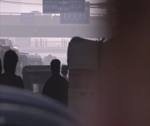 Beijing, China; Tightly packed bicycle and vehicle traffic moving away in smog Stock Footage 86743538