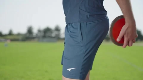 Beijing, July 2, 2024: A professional athlete with a throwing disc walks Stock Footage 320393413