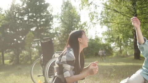 Being energetic and happy, a young pretty couple is playing volleyball in the Stock Footage 174469686