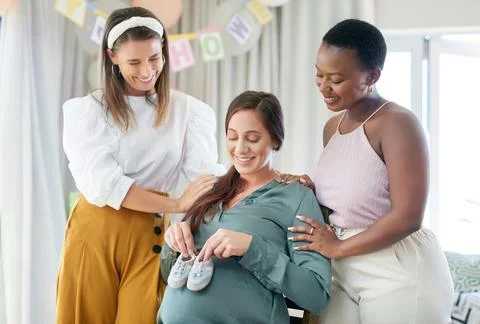 Being reminded of how tiny theyll be. a young mother to be holding her babies Stock Photos