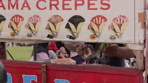 Bekasi, West Java, Indonesia. March 17, 2024: A traveling crepes seller Stock Footage 270777399