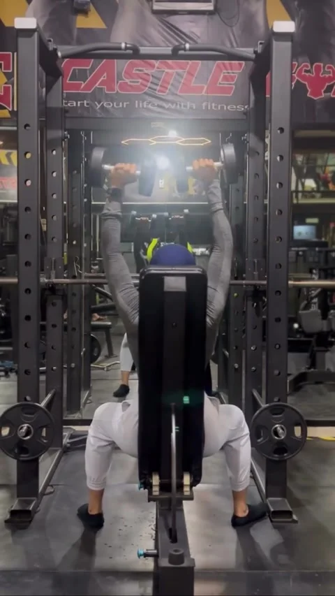 BEKASI, WEST JAVA, INDONESIA – MARCH 30, 2026: A person performs a seated dumbbe Stock Footage 331812333