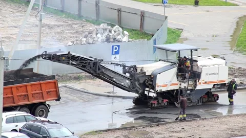 Belarus, Bobruisk 25.03.2024 - A self-propelled road machine mills asphalt road Stock-Footage 296579061