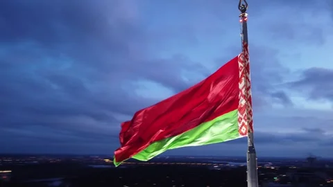 Belarusian flag against the backdrop of the night city of Gomel Stock Footage 254349385