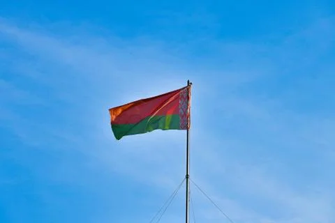 Belarusian flag on sky background. Develops in the wind. Flag of Belarus. Stockfoto's