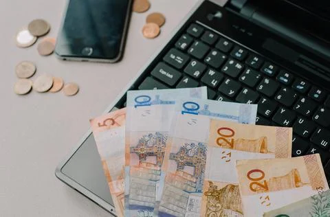 Belarussian banknotes and coins on the computer keyboard. Remote work, freela Stock Photos